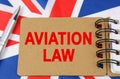 Against the background of the flag of Great Britain lies a notebook with the inscription - AVIATION LAW