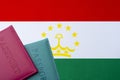 Against the background of the Flag of Tajikistan are passports