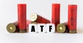 Against the background of rifle cartridges, there are white cubes with text ATF Royalty Free Stock Photo