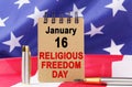 Against the background of the US flag lies cardboard with the inscription - RELIGIOUS FREEDOM DAY