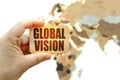 Against the background of the world map, a man holds a sign with the inscription - Global vision Royalty Free Stock Photo