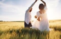 Against beautiful sunlight. Couple just married. Together on the majestic agricultural field Royalty Free Stock Photo