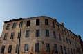 Against the blue sky, an old ruined house. Remnants of old houses. Devastation, The Apocalypse. An abandoned city. Ghost town Royalty Free Stock Photo