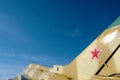 Against the blue sky, the tail part of a military aircraft with a star on the tail Royalty Free Stock Photo