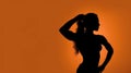 Silhouette of strong empowered woman on orange background