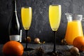 Against a dark background, two glasses with a Mimosa Cocktail. Champagne with orange juice. Festive drink Royalty Free Stock Photo