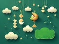 Against a green background, there is a hanging ketupat, a crescent with stars, and paper-cut clouds.