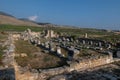 Against the mountainous backdrop of Hierapolis, the remains of ancient structures spread across a vast area, featuring columns and Royalty Free Stock Photo