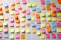 Against a neutral background, a hand arranges colorful sticky notes. AI Generated Royalty Free Stock Photo
