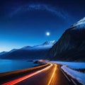 Against the sea at the foot of the mountains at night the road trailing car tail lights under a beautiful starry