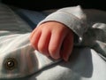 Newborn baby in onsie with close up of hand Royalty Free Stock Photo