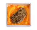 Agarwood, also called aloeswood oudh. in the plastic box. Isolated on white background