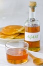 Agave syrup and a plate of pancakes.