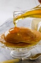 Agave syrup pouring on a plate of pankakes. Royalty Free Stock Photo