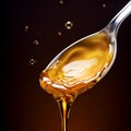 Agave syrup. Spoon with agave syrup and drops on a dark marron background with copy space. Alternative sugar, natural sweetener,