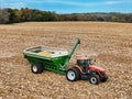 AGCO DT180 tractor pulling a Killbros 1950 grain cart laded with corn Royalty Free Stock Photo
