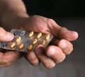 Close up of senior man hands holding pills Royalty Free Stock Photo