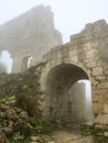 Age-old stronghold gate arched mist morning