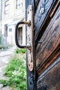 Age-old Wooden Door into Yard with Rusty Iron Handle Royalty Free Stock Photo