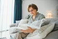 age and people concept - happy senior woman reading newspaper at home Royalty Free Stock Photo