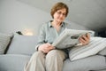 age and people concept - happy senior woman reading newspaper at home Royalty Free Stock Photo