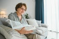 age and people concept - happy senior woman reading newspaper at home Royalty Free Stock Photo