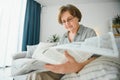 age and people concept - happy senior woman reading newspaper at home Royalty Free Stock Photo