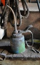 Aged antique dirty oil can centered sitting on an old wooden shelf. Royalty Free Stock Photo