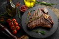Aged Beef T-Bone steak. Juicy cooked steak with rosemary and spices.
