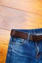 Aged blue jeans with a leather belt Royalty Free Stock Photo