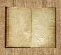 Aged book on burlap background
