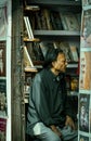 An aged bookseller looking sideways