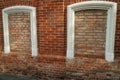 Aged brick wall with four arched bricked up windows with space for text Royalty Free Stock Photo