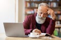 Aged businessman checking his agenda, working at cafe Royalty Free Stock Photo