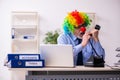 Old businessman clown working in the office Royalty Free Stock Photo