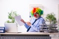 Old businessman clown working in the office Royalty Free Stock Photo