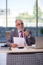 Aged businessman employee working in the office Royalty Free Stock Photo