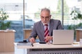 Aged businessman employee working in the office Royalty Free Stock Photo
