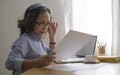 Aged businesswoman checking financial taxes fees, reviewing bank account loan rates information, medical insurance cost Royalty Free Stock Photo