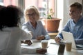 Aged businesswoman shaking hands with company client during business meeting Royalty Free Stock Photo