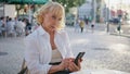 Aged businesswoman typing smartphone at street restaurant closeup. Elderly woman Royalty Free Stock Photo