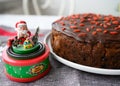 Traditional aged English fruitcake for Christmas. Chocolate covered with guji berries. Royalty Free Stock Photo