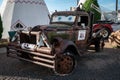 Aged car with Lightning Mcqueen eyes on it, parked in front of the Wigwam Motel, Route 66