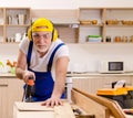 Aged contractor repairman working in the kitchen