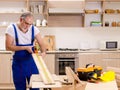 Aged contractor repairman working in the kitchen