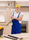 Aged contractor repairman working in the kitchen