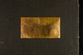 Aged copper plate on black cloth, old worn metal background. Royalty Free Stock Photo
