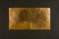 Aged copper plate on black cloth, old worn metal background. Royalty Free Stock Photo