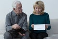 Aged couple analyzing unpaid bills Royalty Free Stock Photo