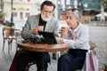 Aged couple using tablet while drinking coffee on terrace Royalty Free Stock Photo